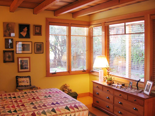 Bedroom looking out into garden.  Cedar ceiling with exposed beams.