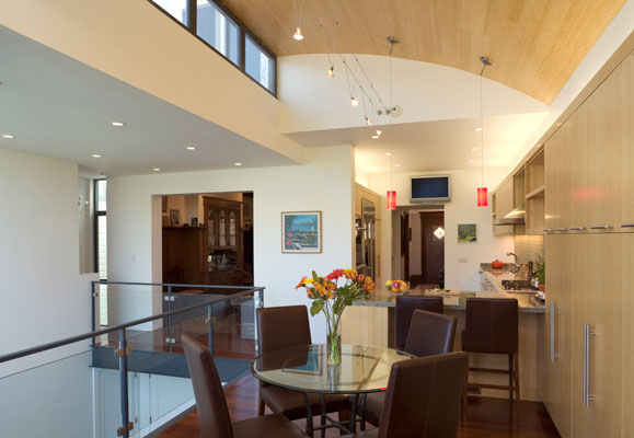 View from dining area into kitchen, showing the steel and glass guardrails.