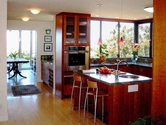 Custom kitchen with island and bar seating and a butler's pantry.