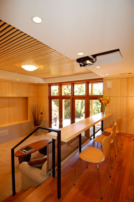 View of home theater from mezzanine level.  Custom bamboo paneling and acoustic baffles complement India teak tiles and cherry flooring.