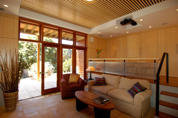New home theater and family room in Berkeley incorporates warm materials, natural light and a dramatic mezzanine level.  Mahogany French doors open to an outdoor terrace.