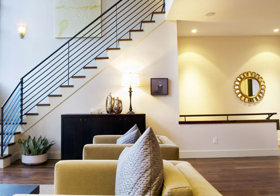 Elegant materials and a double height living room create a dramatic stair.