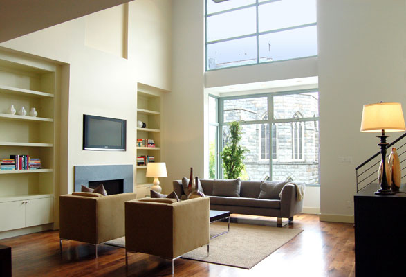 Double height living room with bay and clerestory windows provides abundant natural light.